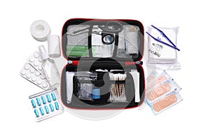 First aid kit, scissors, pins, cotton buds, pills, plastic forceps, hand sanitizer, plasters and elastic bandage isolated