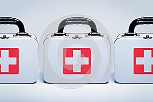 First aid kits in a row on light grey background