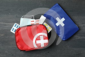 First aid medical kits on dark wooden table