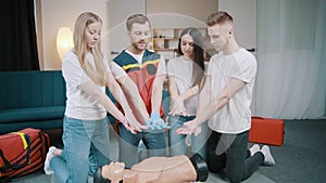 First aid resuscitation, CPR training. Students study in front of a dummy
