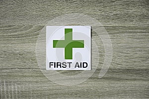 First aid sign on the wooden wall