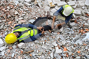 First aid support accident at work of builder worker on the concrete cement rubble in construction site. Knee accident and ankle