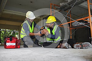 First aid support accident at work of builder worker on floor in the construction site.