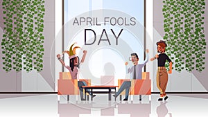 First april fool day mix race businesspeople wearing funny jester hat glasses mustache holiday celebration concept