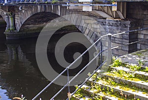 The first arch of the stone built Queen Victoria bridge over the river Lagan in Belfast Northern Ireland.