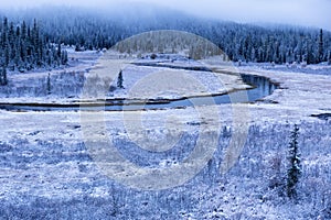 First autumn snow and the river in mountains