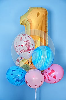 First birthday balloons and golden digit one 1