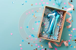 First birthday gift box with number 1 balloon inside, confetti and ribbons on a pastel background