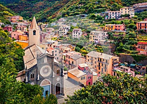 First city of the Cique Terre sequence of hill cities - Riomaggiore with tower of Church of San Giovanni Battista. Wonderful summe