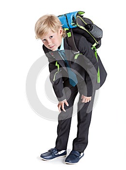 First class student holding heavy schoolbag on the back, full length, isolated white background