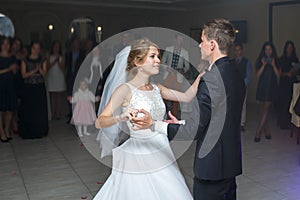 The first dance of gentle stylish happy blonde bride and groom