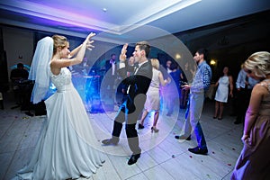 The first dance of gentle stylish happy blonde bride and groom