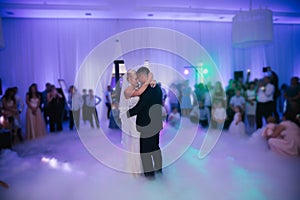 First dance of stylish wedding couple. Handsome groom and elegant bride in the restaurant