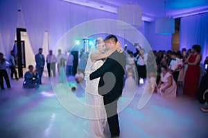 First dance of stylish wedding couple. Handsome groom and elegant bride in the restaurant