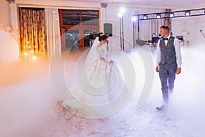 the first dance at the wedding of the bride and groom in an elegant restaurant with great lighting