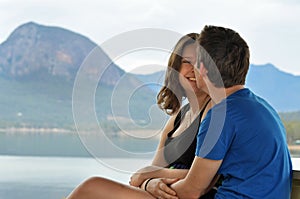 First date for happy young couple at scenic lake