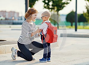 First day at school. mother leads  little child boy in grade