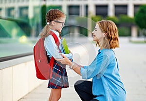 First day at school. mother leads  little child girl in grade