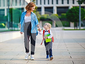 First day at school. mother leads  little child school boy in first grade