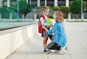 First day at school. mother leads  little child school girl in first grade