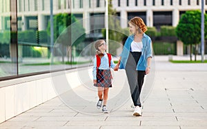 First day at school. mother leads  little child school girl in first grade