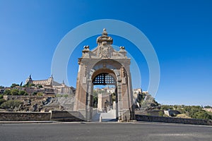 First door in Alcantara bridge with Toledo city in background