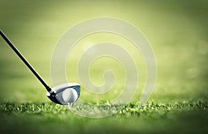 The first drive is vital. A golf club ready to tee-off with a white ball on a golf course.