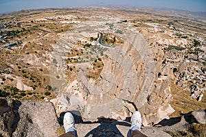 First face look. Uchisar Castle. Tourist at the top of the fortress, mountains, view of Cappadocia. Man lags, male Traveler at