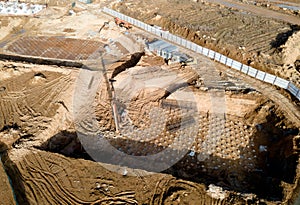 First floor slab rebar installation. Pile driver at construction site. Pile driven into ground by vibrating hydraulic hammer.