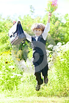 First-form schoolboy with flowers and satchel