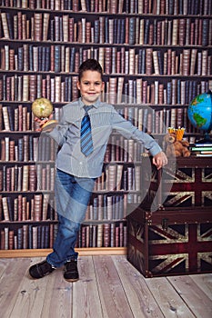 First-grader boy with a board in a library