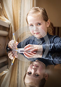 First grader girl writes