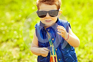 First investment concept. Portrait of baby boy with coin