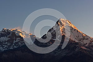 First light of the day hitting Annapurna & Annapurna South as viewed from Poon Hill summit, Nepal