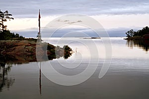 First light reveals flagpole at entrance to Killarney Channel, Killarney, Ontario