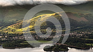 First light streams across Keswick on the shores of Derwentwater in the English Lake District