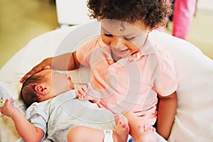 First meeting of adorable african toddler boy and his newborn brother