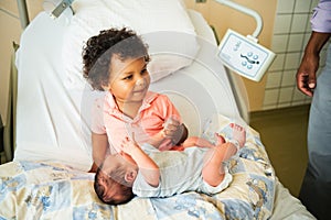 First meeting of adorable african toddler boy and his newborn brother