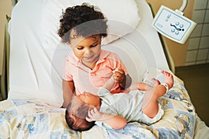 First meeting of adorable african toddler boy and his newborn brother