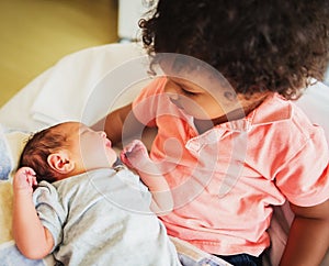 First meeting of adorable african toddler boy and his newborn brother