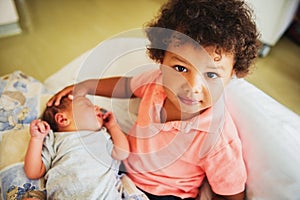 First meeting of adorable african toddler boy and his newborn brother