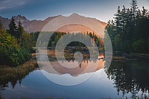 First morning light in mountains. Scenry by lake. Hiking photo. High Tatras, Slovakia