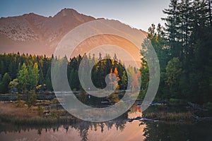 First morning light in mountains. Scenry by lake. Hiking photo. High Tatras, Slovakia