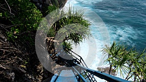 First-person video of a suitable person on an old wooden stairs to a cliff on a high mountain