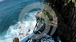 First-person video of a suitable person on an old wooden stairs to a cliff on a high mountain