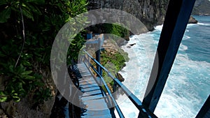 First-person video of a suitable person on an old wooden stairs to a cliff on a high mountain