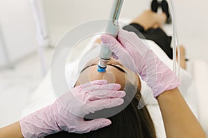 First-person view of cosmetologist doing beauty procedure at cosmetology clinic