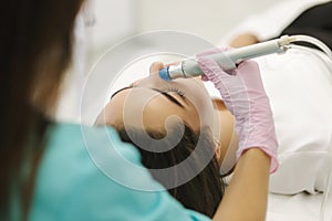 First-person view of cosmetologist doing beauty procedure at cosmetology clinic