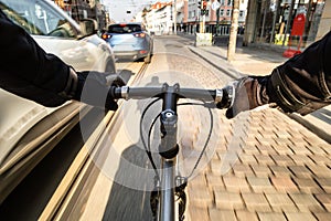 First-person view of cyclist in the city at morning