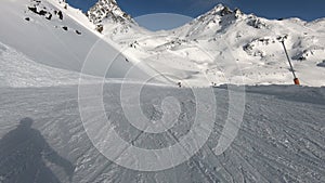 first person view downhill skiing mountain slope in Alps. Freeride skier skiing in backcountry mountain ski resort.
